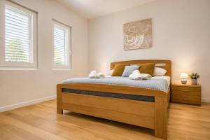a bedroom with a bed with two stuffed animals on it at Luma Luxury Apartment - 5 min Walk to the Beach in Sutomišćica