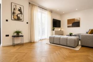a living room with a bed and a couch at Luma Luxury Apartment - 5 min Walk to the Beach in Sutomišćica