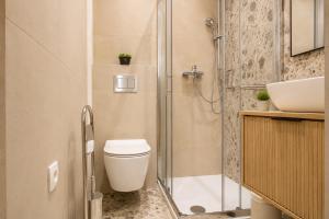 a bathroom with a shower and a toilet and a sink at Luma Luxury Apartment - 5 min Walk to the Beach in Sutomišćica +24 photos