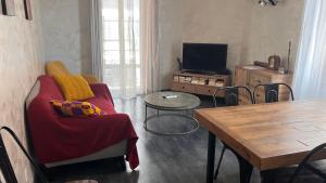 a living room with a couch and a table at Eden Riviera in Beausoleil