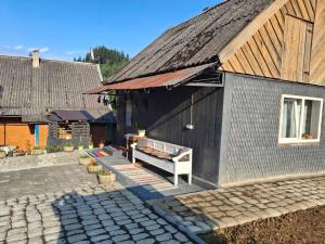 a building with a table on the side of it at Бабусині маєтки in Lazeshchyna +14 photos