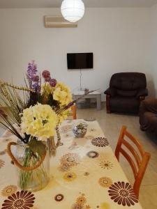 a table with a vase of flowers on it at Millennium falcon in Larnaca