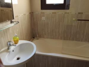 a bathroom with a sink and a bath tub at Millennium falcon in Larnaca +26 photos