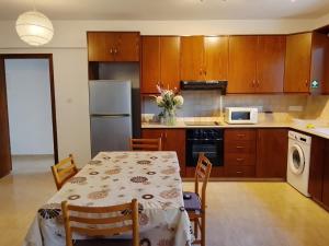 a kitchen with a table and chairs and a kitchen with a refrigerator at Millennium falcon in Larnaca