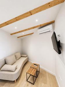 a living room with a couch and a tv at Blue Diamond Rooms in Zaton