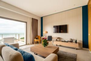 a living room with a couch and a table at Zephyr Mazagan in El Jadida