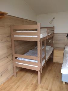 two bunk beds in a room with wooden walls at Kungshamns Vandrarhem in Kungshamn