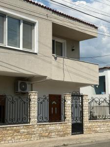 a house with a fence and a door at Tirana Terminal Stay in Tirana +1 photo
