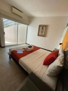 a large bed in a room with a window at Apartment with Pool, Gym & A/C in Querétaro +19 photos