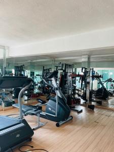 a gym with a bunch of exercise equipment in it at Apartment with Pool, Gym & A/C in Querétaro