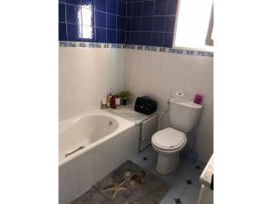 a bathroom with a tub and a toilet and a sink at Villa Jasmin Zarzis in Zarzis