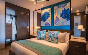 a bedroom with a large bed with blue walls at Suites at Zona Romantica in Puerto Vallarta