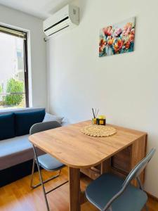 a living room with a wooden table and chairs at Byla Central Studio in Byala +3 photos