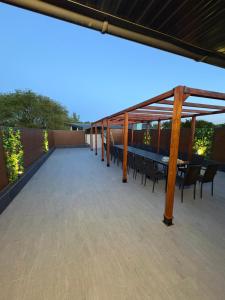 a large deck with a table and chairs on a roof at Apartmani Harmonija in Vrbas