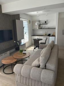 a living room with a couch and a table at Apartmani Harmonija in Vrbas