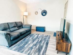 a living room with a couch and a flat screen tv at Cozy Comfort 1BR - Renovated, Private, Pet Welcome in Texas City