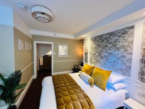 a bedroom with a large bed with yellow pillows at Ferndale Mews in Bristol