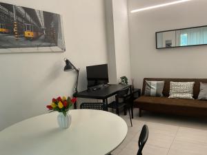 a living room with a table and a piano at Ripalta House in San Donato Milanese