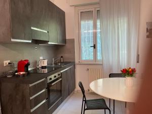 a kitchen with a table and a counter top at Ripalta House in San Donato Milanese