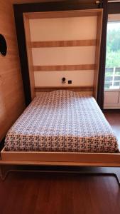 an empty bed in a room with a window at Studio pistes La Bresse Hohneck in La Bresse
