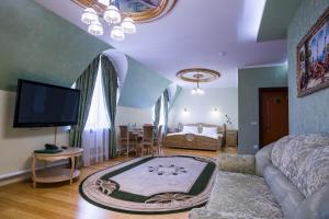 a living room with a couch and a tv at Barskiye Polati Hotel in Sergiyev Posad