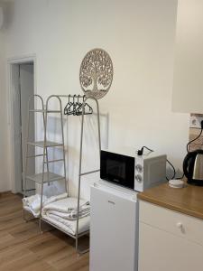 a kitchen with a microwave on top of a refrigerator at Haromfa Apartman in Háromfa +24 photos
