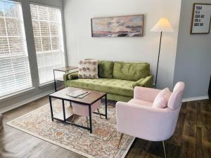 a living room with a couch and a chair and a table at Pool View Escape - Near Shops and Dining in Corpus Christi