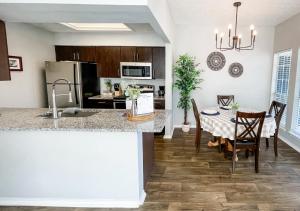 a kitchen and dining room with a table and chairs at Pool View Escape - Near Shops and Dining in Corpus Christi