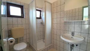 a bathroom with a toilet and a sink and a shower at Apartmani Nina in Starigrad +42 photos