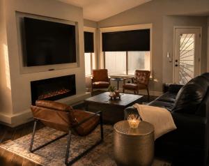 a living room with a couch and a fireplace at Desert Disconnect Outdoor Cinema and Pool in Mesa