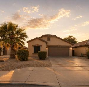 a house with a palm tree and a driveway at Desert Disconnect Outdoor Cinema and Pool in Mesa