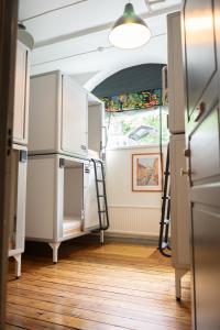 a room with two ladders and a refrigerator at City Backpackers Hostel in Stockholm