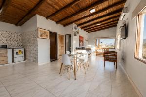 a kitchen and dining room with a table and chairs at Amplios Departamentos con Vistas a los cerros - Patio, Asador y Pileta in Tafí del Valle