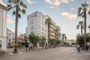 an architectural rendering of a building in a city with palm trees at Suite 33 - Boutique Apartments in San Benedetto del Tronto