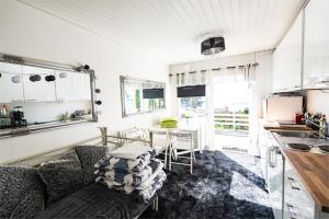 a living room with a couch and a table at Airisto Hill & Inn - Two Beach Cabins in Haverö