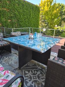 a patio with a table with a blue table top at Apartmán Extoll in Třeboň