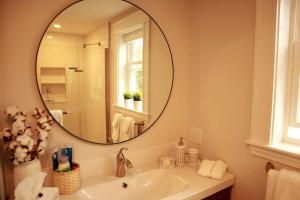 a bathroom with a sink and a large mirror at 2BR Suite - Bright - Modern - Central AC - Parking in Arlington +12 photos