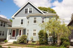 a white house with a red door at 2BR Suite - Bright - Modern - Central AC - Parking in Arlington