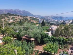 a view of a hill with trees and a city at Laertis house in Himare +18 photos
