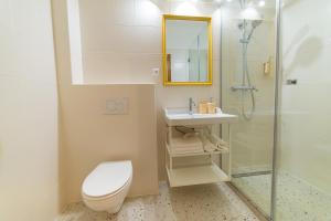 a bathroom with a toilet and a sink and a shower at WanaBark Hotel - The Ultimate Dogs-friendly Spot in Bratislava in Bratislava