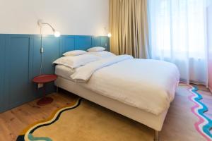 a bedroom with a large bed with a rainbow carpet at WanaBark Hotel - The Ultimate Dogs-friendly Spot in Bratislava in Bratislava