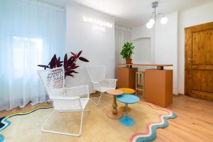 a living room with chairs and a table on a rug at WanaBark Hotel - The Ultimate Dogs-friendly Spot in Bratislava in Bratislava