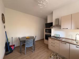 a kitchen with a table and a dining room at Forte dei marmi casa vacanza in Forte dei Marmi