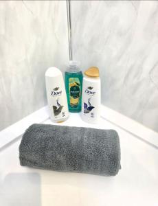 a bathroom with two products on a white counter at Newly Refurbished Townhouse in Derry Londonderry