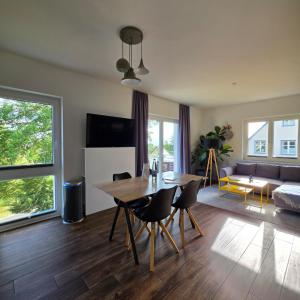 a living room with a table and a couch at Villa Eckhart in Göhren