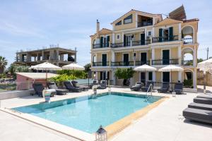 a villa with a swimming pool in front of a building at Remenata in Lixouri