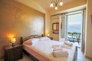 a bedroom with a bed and a large window at Remenata in Lixouri +89 photos