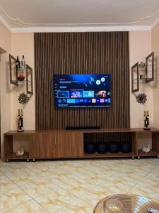a living room with a large flat screen tv at LILY'S spa and accomodations in Mukono