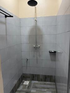 a shower with a glass door in a bathroom at LILY'S spa and accomodations in Mukono