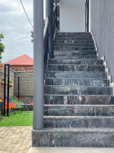a set of concrete stairs next to a building at LILY'S spa and accomodations in Mukono